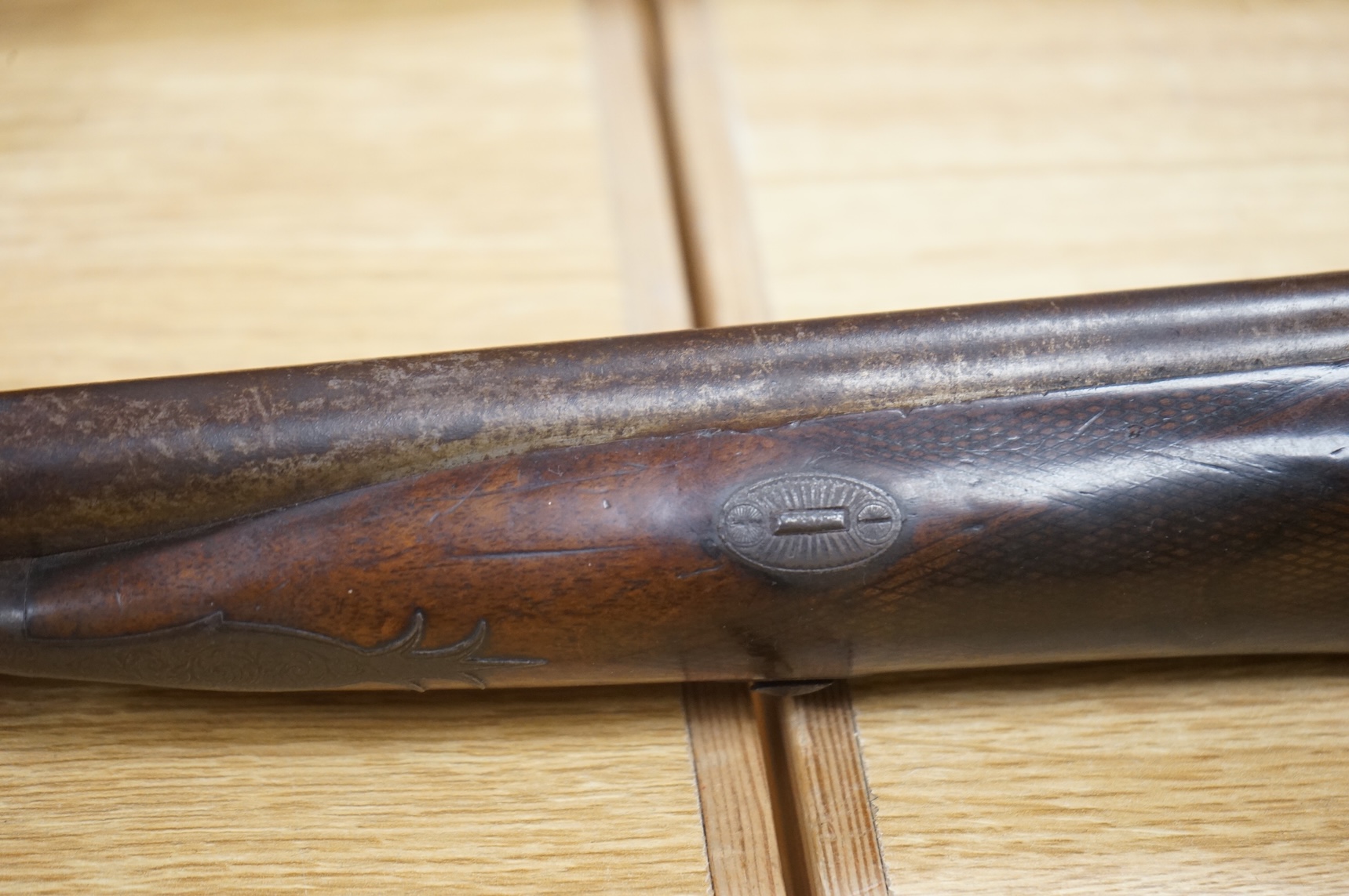 A double barrel 12 bore percussion sporting gun, signed Cocksedge, Hadleigh, with engraved locks and iron furniture, half stocked chequered grip with finger support in wood above guard